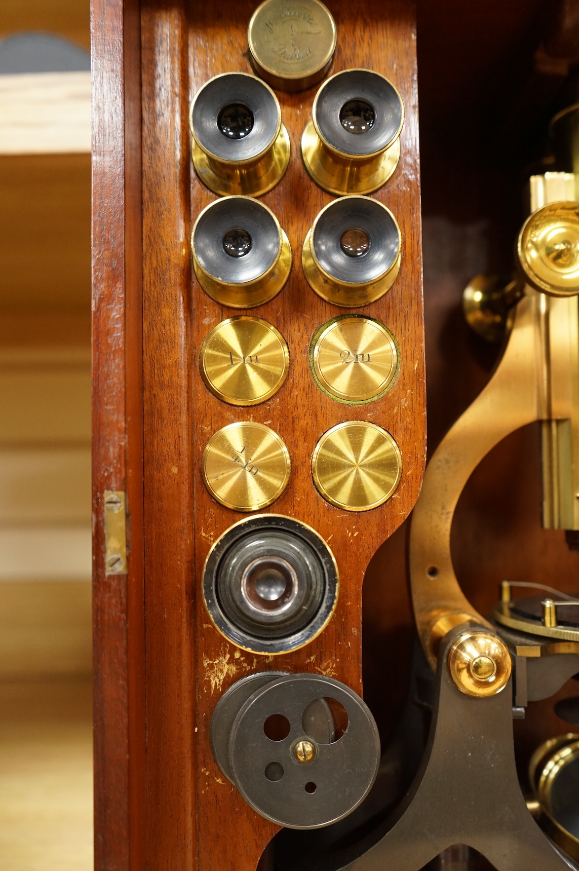 A Victorian binocular brass microscope, unsigned, in a fitted, glass fronted case with a good selection of alternative lenses and accessories, all in fitted compartments, plus three integral drawers to hold microscope sl